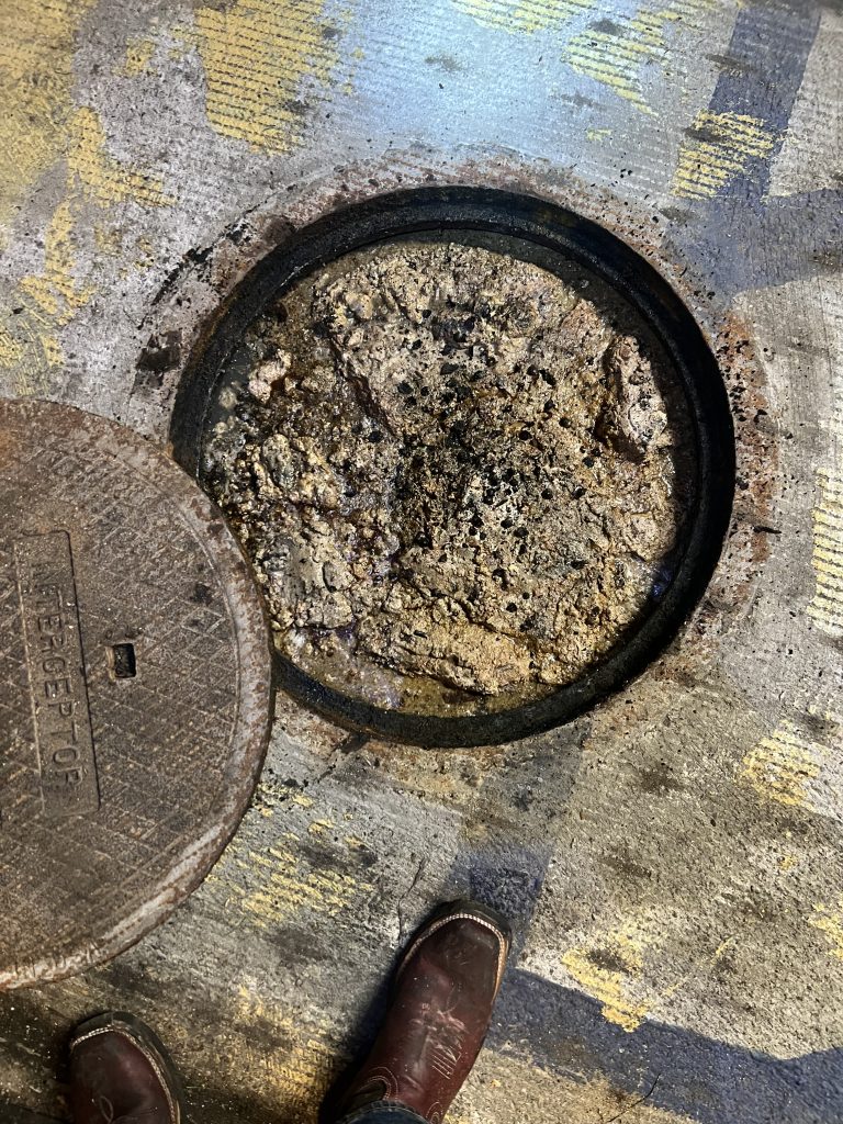 Overflowing Grease Trap.  Full Grease Trap.
