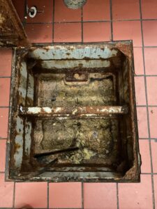 Damaged grease trap in Koreatown Los Angeles needing emergency grease trap replacement services.