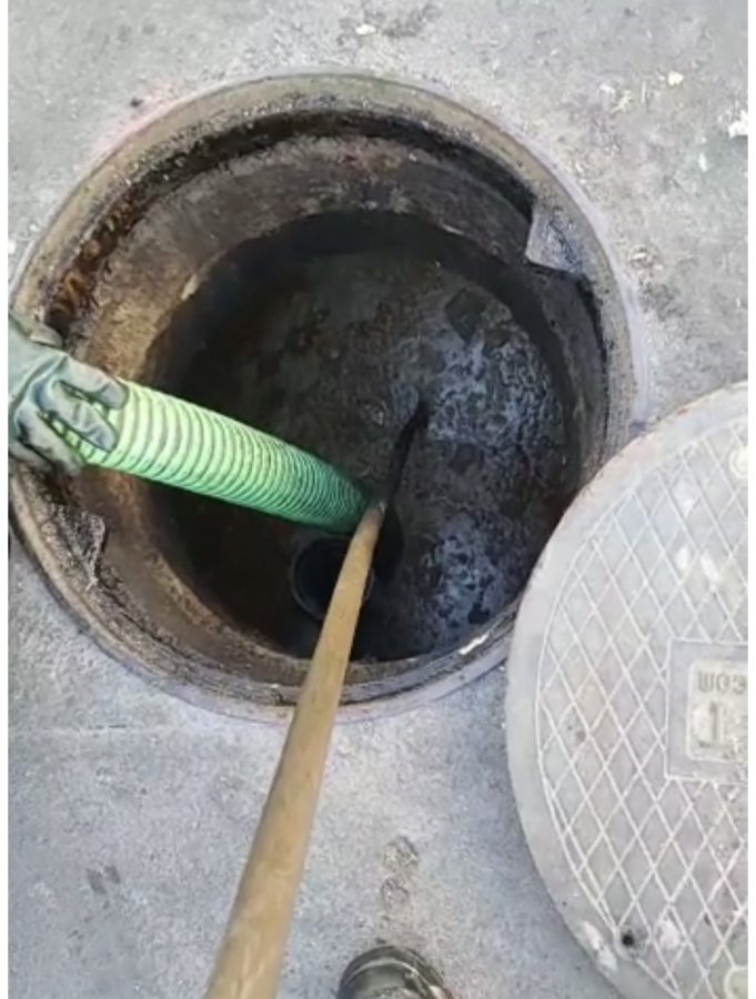 Cleaning a grease trap in Los Angeles for a commercial restaurant kitchen.