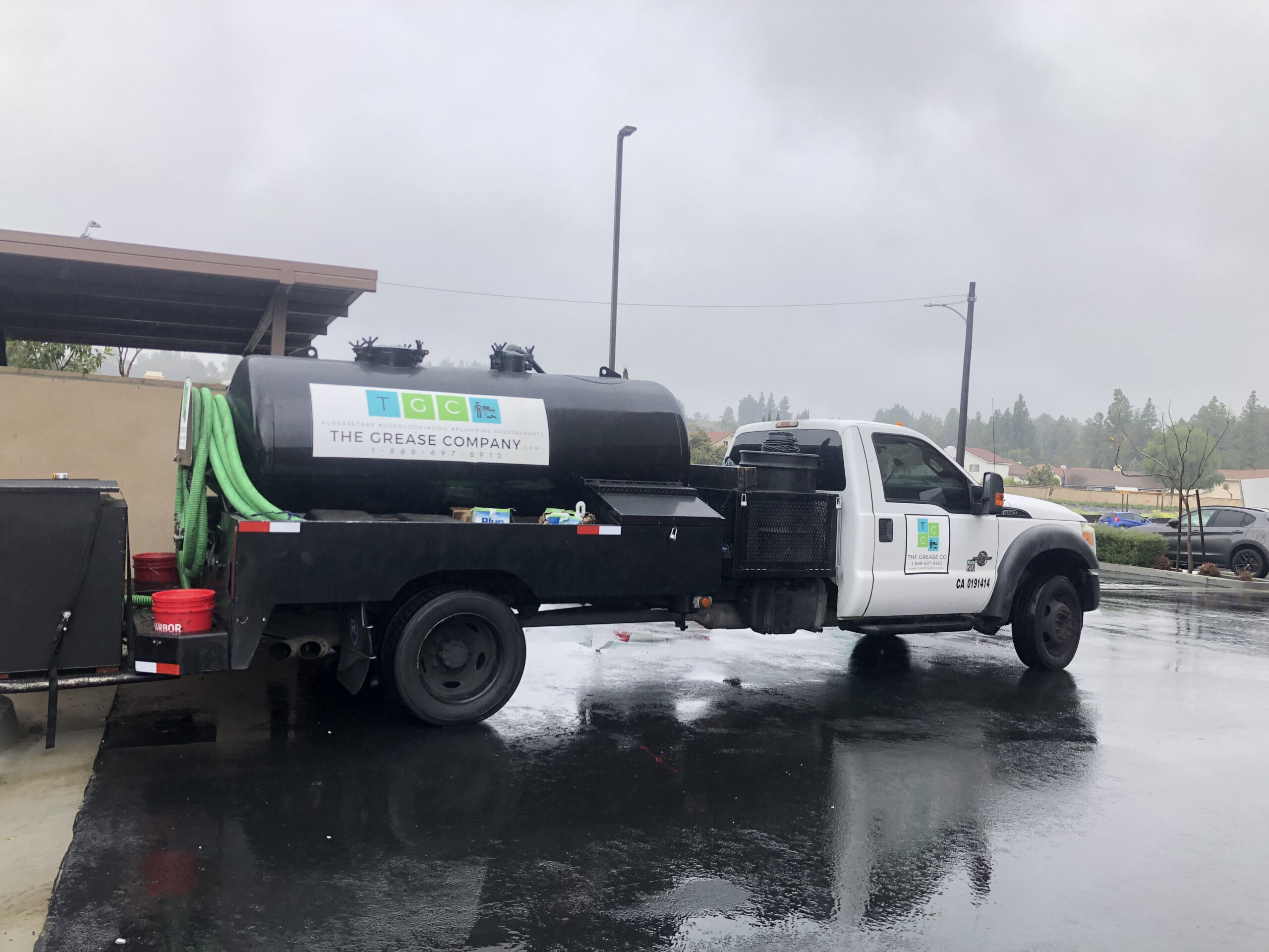 Grease trap pumping service truck parked outside restaurant facility in Southern California for commercial grease removal