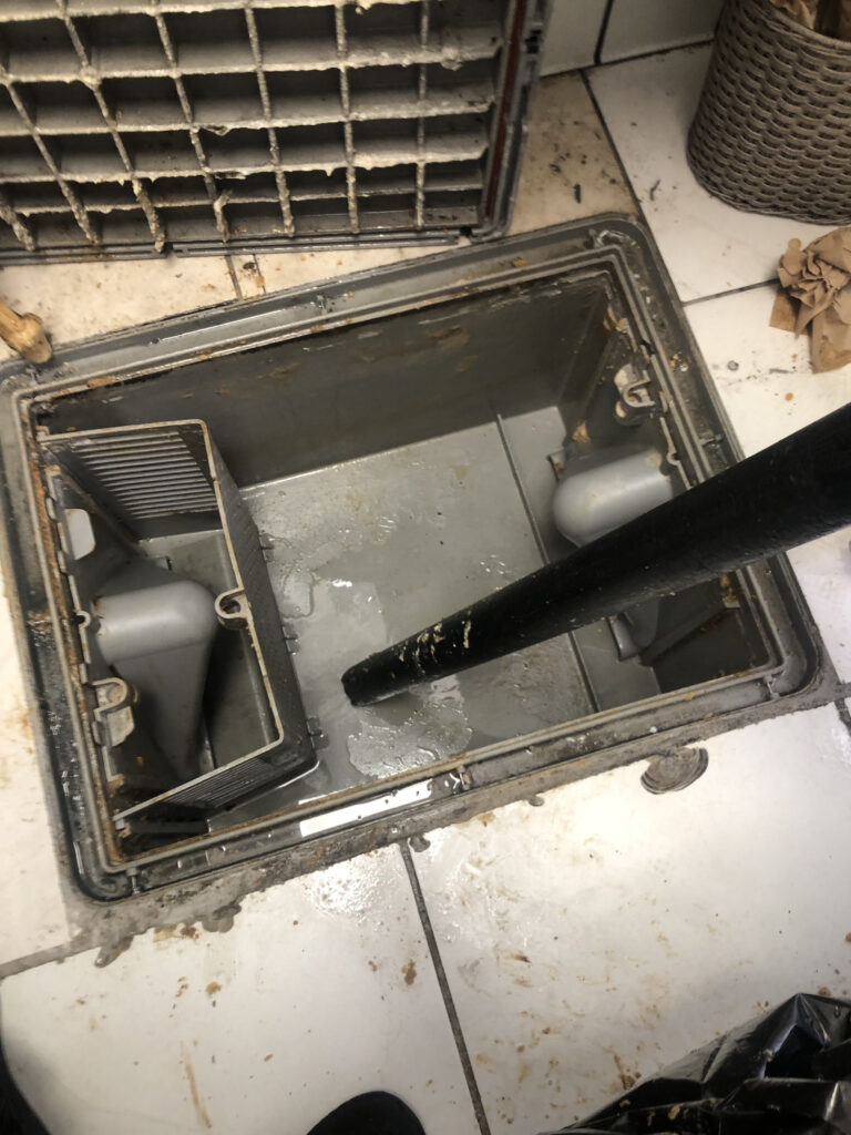 Technicians providing grease trap service at affordable grease trap pumping cost