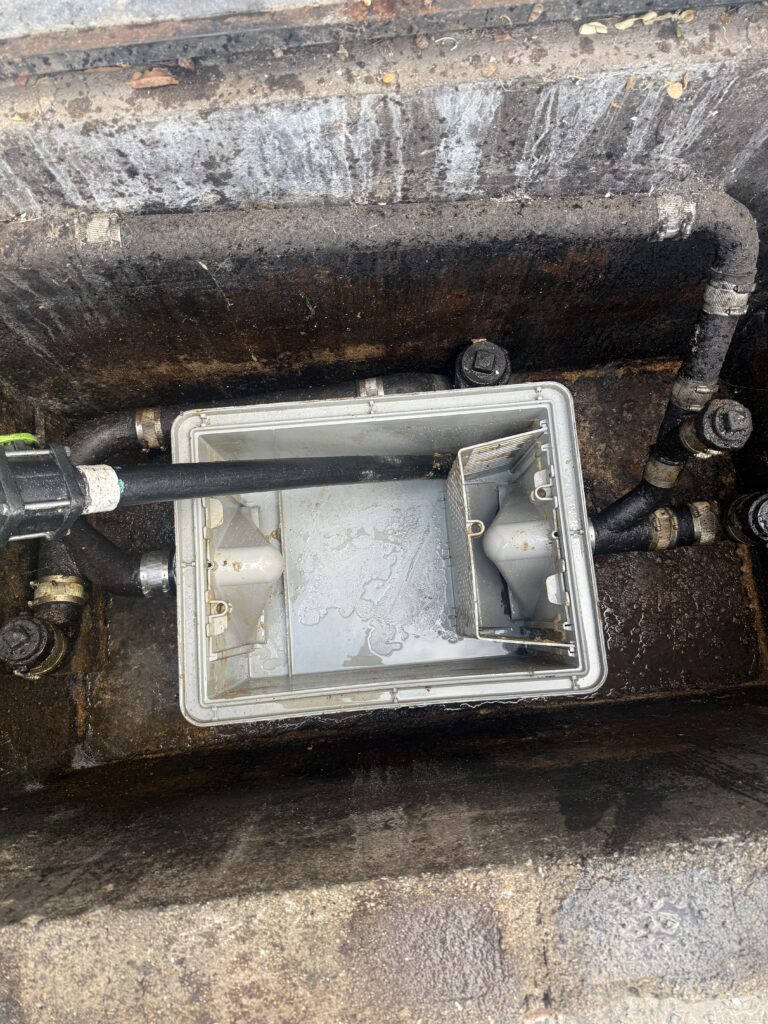 Cleaner grease trap after routine professional grease trap maintenance service by The Grease Company.
