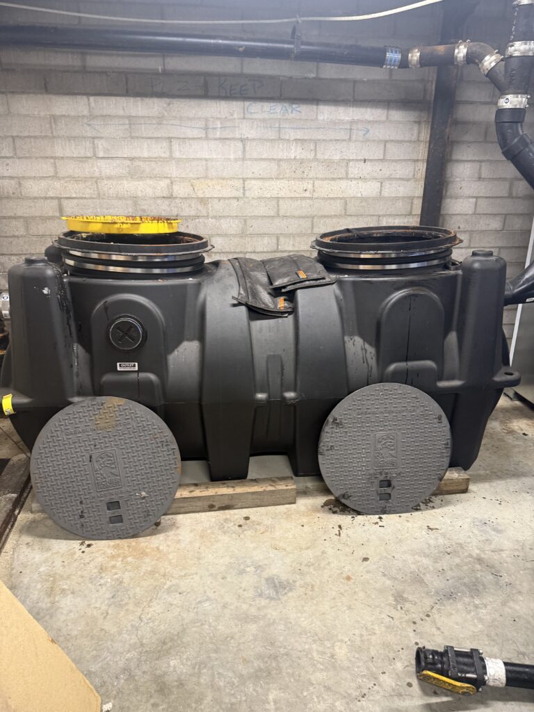 Large underground grease trap requiring professional service instead of DIY grease trap cleaning.
