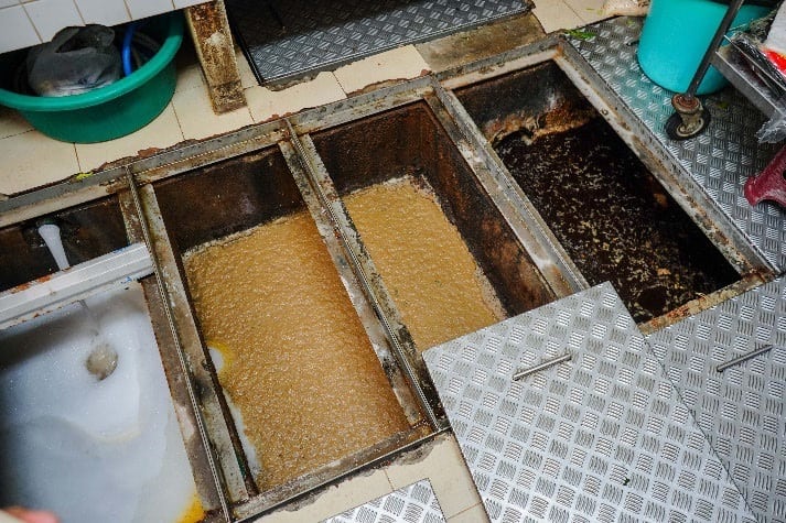 Grease trap maintenance for a commercial restaurant kitchen grease management system.